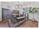 Bright dining room with wooden table, stylish chairs and a bench with modern light fixture and accent wall at 4853 Chapelle Ct, Marietta, GA 30066