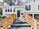 Charming entrance with a modern gray deck, wooden railing, and lovely landscaping at 4853 Chapelle Ct, Marietta, GA 30066