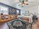 Charming main bedroom featuring a ceiling fan, a decorative wall and a well-lit room with hardwood floors at 4853 Chapelle Ct, Marietta, GA 30066