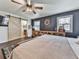 Comfortable main bedroom featuring a stylish barn door and a storage console with a window view at 4853 Chapelle Ct, Marietta, GA 30066