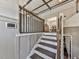 Modern staircase with dark wood steps and railing and neutral walls leading to the main level at 4853 Chapelle Ct, Marietta, GA 30066