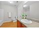 Well lit bathroom features a vanity with granite counters and tub-shower combo at 7316 Wagon Wheel Ct, Jonesboro, GA 30236