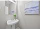 Bathroom featuring a pedestal sink, a decorative painting, and modern fixtures at 7316 Wagon Wheel Ct, Jonesboro, GA 30236
