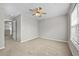 Bedroom features neutral walls and carpet plus a ceiling fan at 7316 Wagon Wheel Ct, Jonesboro, GA 30236