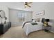 Bedroom featuring a plush bed, modern decor, carpeted floors, and a ceiling fan at 7316 Wagon Wheel Ct, Jonesboro, GA 30236