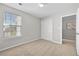 Bedroom with double closet, window and neutral-toned carpet at 7316 Wagon Wheel Ct, Jonesboro, GA 30236