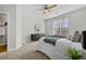 Spacious bedroom featuring cozy carpet, a ceiling fan, and modern design elements at 7316 Wagon Wheel Ct, Jonesboro, GA 30236