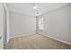 Carpeted bedroom featuring a window and neutral-toned walls at 7316 Wagon Wheel Ct, Jonesboro, GA 30236