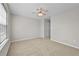 Bedroom features neutral walls and carpet, plus a ceiling fan and window at 7316 Wagon Wheel Ct, Jonesboro, GA 30236
