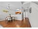 Dining area features hardwood floors, a modern light fixture, and a view to the kitchen at 7316 Wagon Wheel Ct, Jonesboro, GA 30236