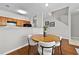 Charming dining room with hardwood floors, modern light fixture, neutral walls, and adjacent kitchen at 7316 Wagon Wheel Ct, Jonesboro, GA 30236
