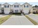 Neat row of townhomes, each featuring attached garages and well-manicured front lawns at 7316 Wagon Wheel Ct, Jonesboro, GA 30236