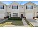 Inviting townhome showcasing classic architecture, black shutters, and a cozy front yard at 7316 Wagon Wheel Ct, Jonesboro, GA 30236