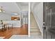 Inviting foyer featuring a staircase, open view to the dining area, and hardwood floors at 7316 Wagon Wheel Ct, Jonesboro, GA 30236