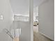Upstairs hallway with tile landing, carpet and a glimpse of the living area at 7316 Wagon Wheel Ct, Jonesboro, GA 30236