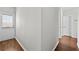 Neutral-toned hallway featuring wood-look flooring, grey walls and access to the exterior at 7316 Wagon Wheel Ct, Jonesboro, GA 30236