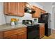Kitchen features wooden cabinets, neutral countertops, and modern black appliances at 7316 Wagon Wheel Ct, Jonesboro, GA 30236