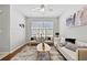 Bright living room showcasing modern furniture, neutral walls, hardwood floors, and natural light at 7316 Wagon Wheel Ct, Jonesboro, GA 30236