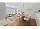 Bright living room with hardwood floors, neutral paint, modern furniture, and large windows at 7316 Wagon Wheel Ct, Jonesboro, GA 30236