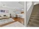 Open-concept living room with hardwood floors, staircase, dining area, and neutral color palette at 7316 Wagon Wheel Ct, Jonesboro, GA 30236