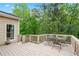 Outdoor deck with a table and chairs, perfect for enjoying the surrounding wooded scenery at 994 Fairview Club Cir, Dacula, GA 30019