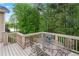 Relaxing outdoor deck featuring seating and scenic views of the lake and surrounding lush trees at 994 Fairview Club Cir, Dacula, GA 30019