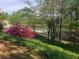 Lush backyard with mature trees surrounding a serene lake at 994 Fairview Club Cir, Dacula, GA 30019