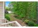 Backyard shot features mature trees and a lake with the view from the deck stairs at 994 Fairview Club Cir, Dacula, GA 30019