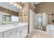 Bright bathroom with a double sink vanity, a glass shower, and large soaking tub at 994 Fairview Club Cir, Dacula, GA 30019