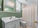 A full bathroom featuring a shower and tub combination, toilet, and single sink vanity at 994 Fairview Club Cir, Dacula, GA 30019