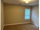 Neutral bedroom features a single window and plush carpeting at 994 Fairview Club Cir, Dacula, GA 30019