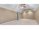 Spacious carpeted bedroom with a ceiling fan and natural light at 994 Fairview Club Cir, Dacula, GA 30019
