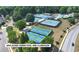 Aerial view of the Apalachee Farms pool and clubhouse featuring tennis and pickleball courts at 994 Fairview Club Cir, Dacula, GA 30019
