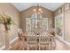 Dining room with a large window, hardwood floors, and decorative chandelier at 994 Fairview Club Cir, Dacula, GA 30019
