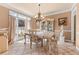 Elegant dining room with tile floors, natural light, and an ornate chandelier at 994 Fairview Club Cir, Dacula, GA 30019
