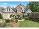 Charming two-story home with stone accents, lush landscaping, and a well-manicured front yard at 994 Fairview Club Cir, Dacula, GA 30019