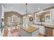 Open kitchen featuring granite counters, a large island, and hardwood floors at 994 Fairview Club Cir, Dacula, GA 30019