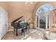Bright living room with tile floors, large window, and a piano at 994 Fairview Club Cir, Dacula, GA 30019