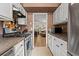 Galley kitchen featuring modern appliances and a view into the living room at 544 Stratford Grn, Avondale Estates, GA 30002