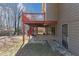 Exterior of a house with a back deck, outdoor stairs, and under-deck entertainment area at 742 Wilkes Dr, Loganville, GA 30052