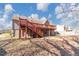 Large, fenced backyard featuring an elevated deck and mature trees at 742 Wilkes Dr, Loganville, GA 30052