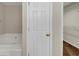 Bathroom featuring a tub, door and walk in closet for all your needs at 742 Wilkes Dr, Loganville, GA 30052