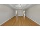 Bright bedroom features hardwood floors, neutral walls and tray ceiling with fan at 742 Wilkes Dr, Loganville, GA 30052