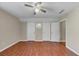 Bedroom with laminate flooring, ceiling fan, and multiple closets, offering both style and ample storage at 742 Wilkes Dr, Loganville, GA 30052