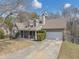 Charming two-story home boasts a covered front porch and mature landscaping at 742 Wilkes Dr, Loganville, GA 30052
