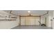 Spacious garage interior features an epoxy floor, ladder and shelving for easy storage at 742 Wilkes Dr, Loganville, GA 30052