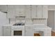 A kitchen featuring white cabinets, countertops, and appliances offering a clean and classic look at 742 Wilkes Dr, Loganville, GA 30052