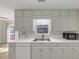 A kitchen featuring white cabinets, countertops, and stainless steel appliances at 742 Wilkes Dr, Loganville, GA 30052
