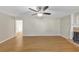 Bright living room offers hardwood floors and fireplace, adjacent to an open doorway at 742 Wilkes Dr, Loganville, GA 30052