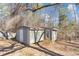 A back view of a painted shed with white doors and small deck with steps at 742 Wilkes Dr, Loganville, GA 30052